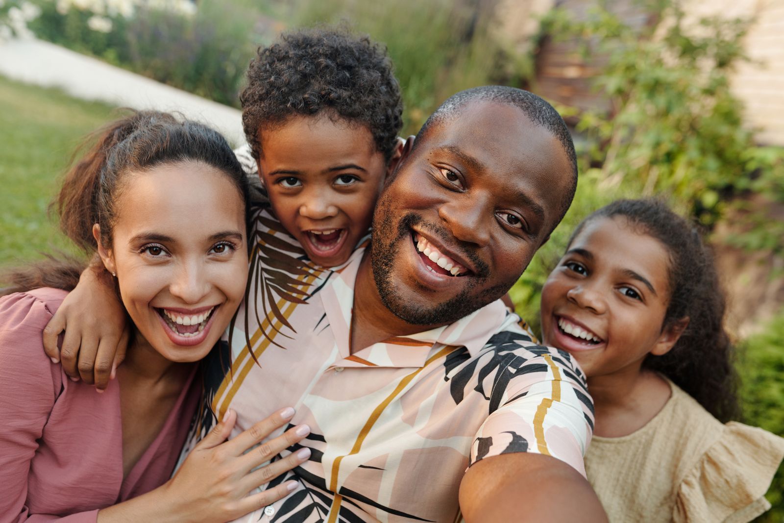 Multigenerational family together outdoors in their garden